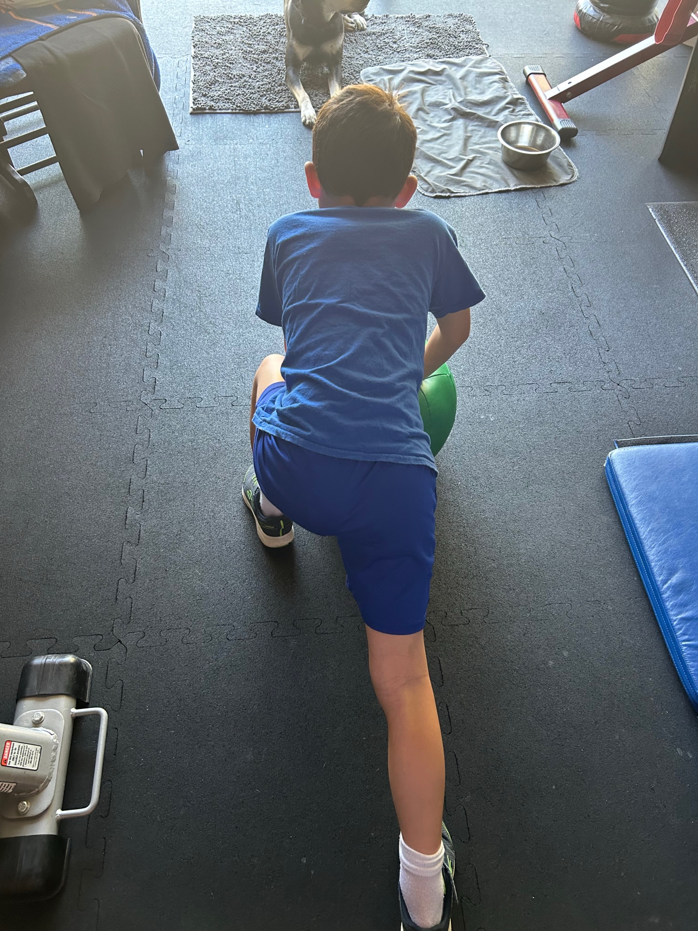 Youth athlete lunging with medicine ball