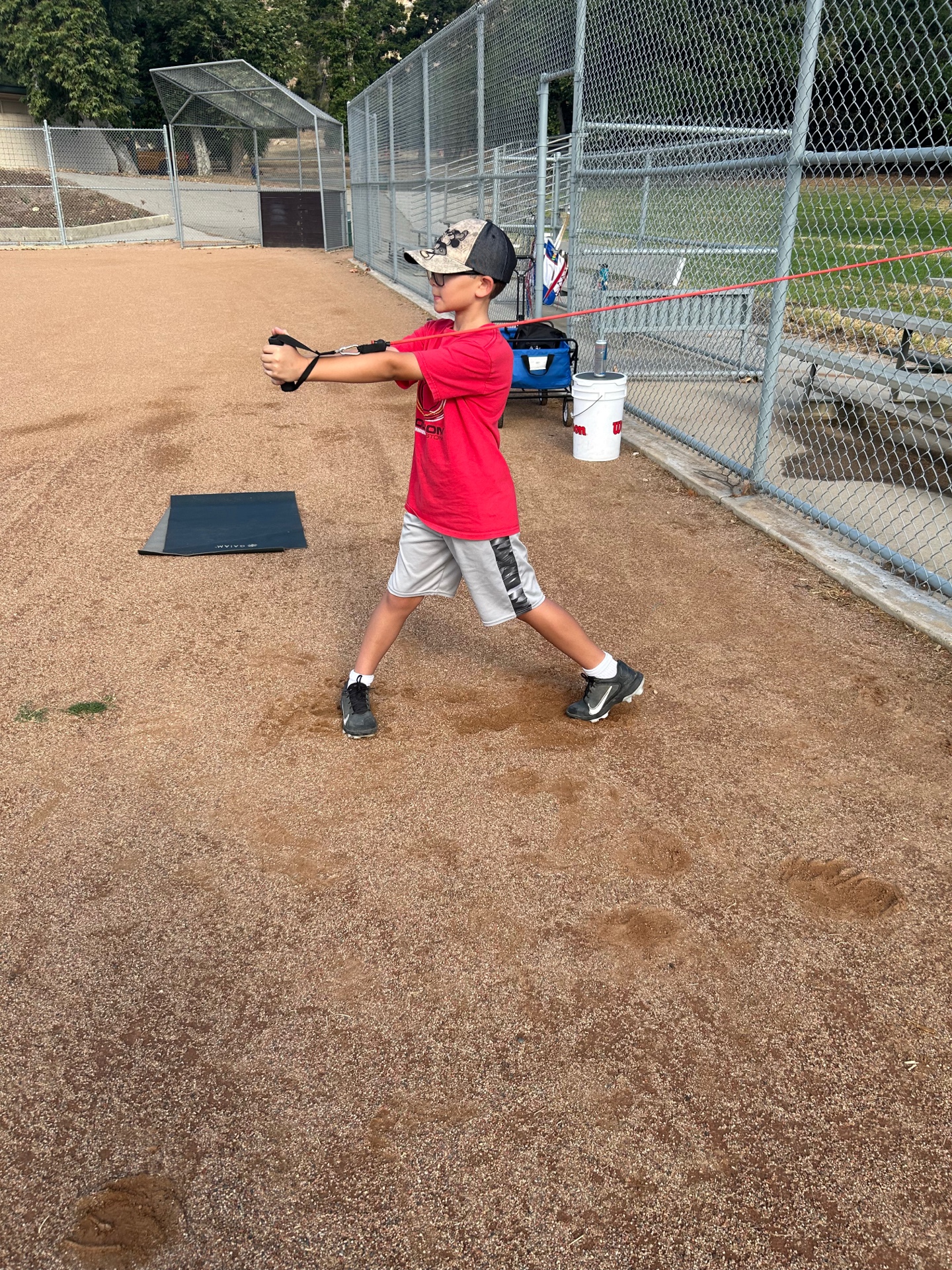 Youth baseball player band training on field